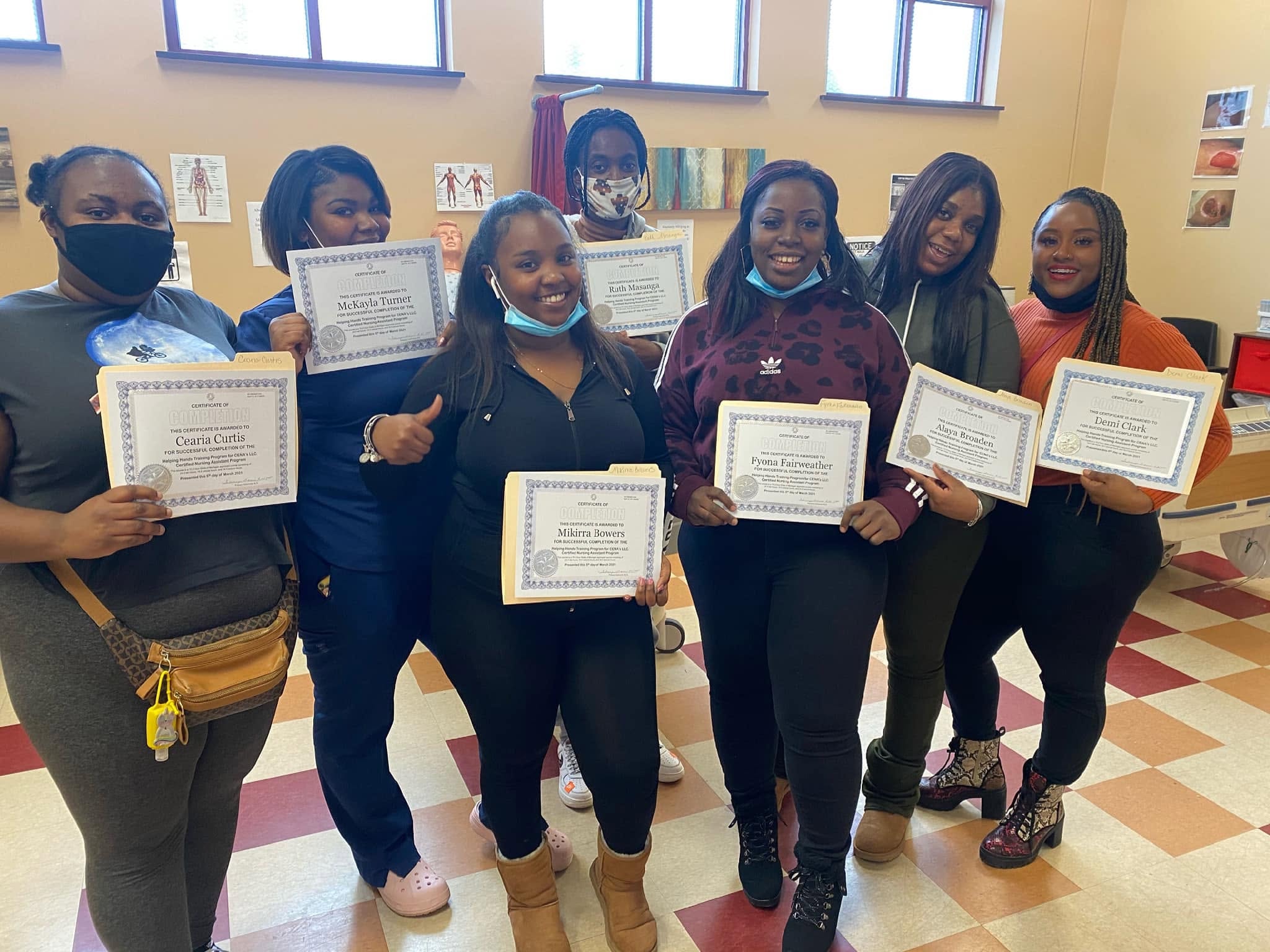 Helping Hands graduates celebrating with completion certificates