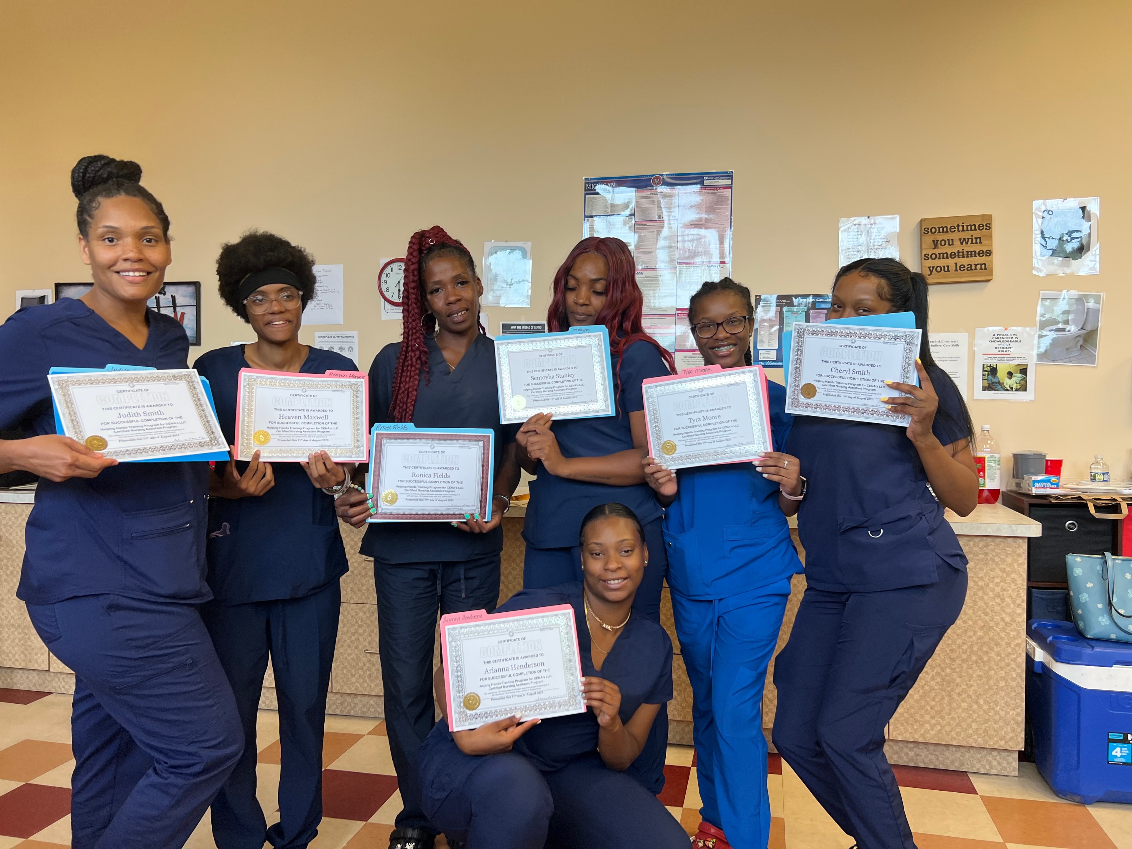 Helping Hands graduates holding certificates of completion